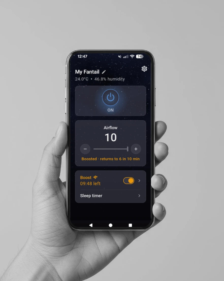 A hand holding a phone showing the Fantail app with Boost active, airflow at 10, returning to 6 in 10 minutes