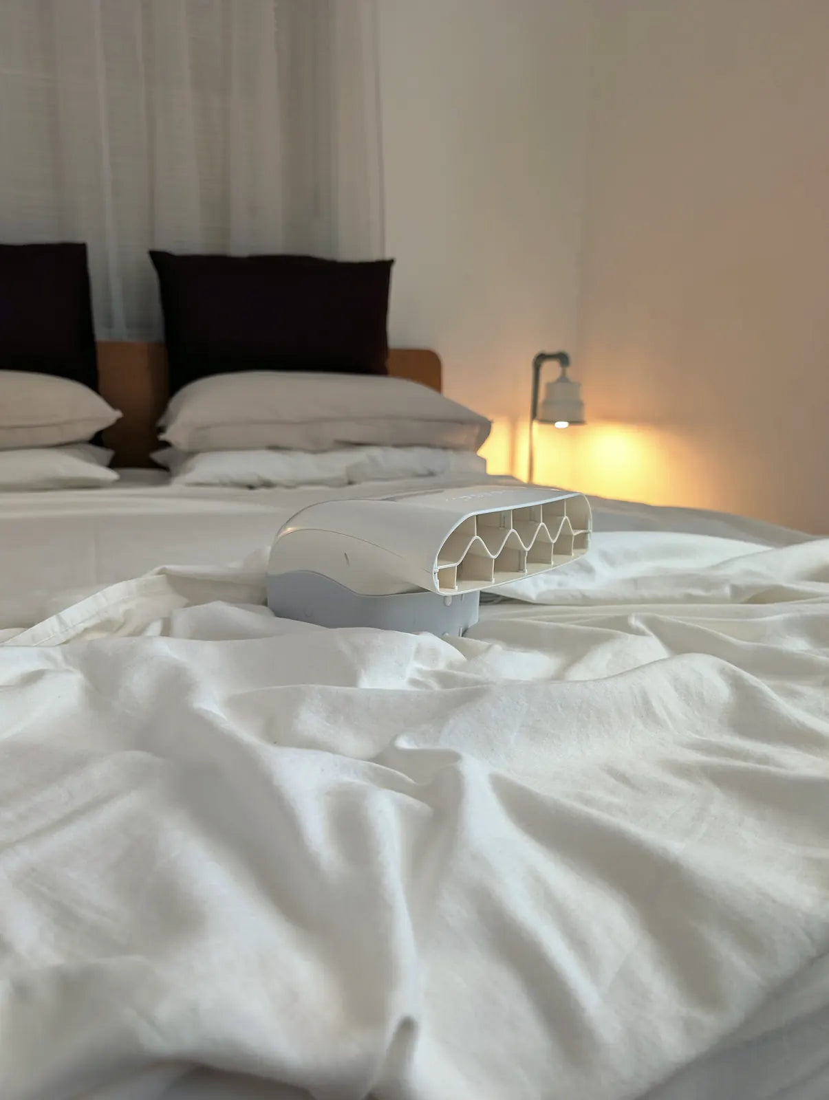 A Fantail unit resting on white linen, the honeycomb air outlet facing the camera.