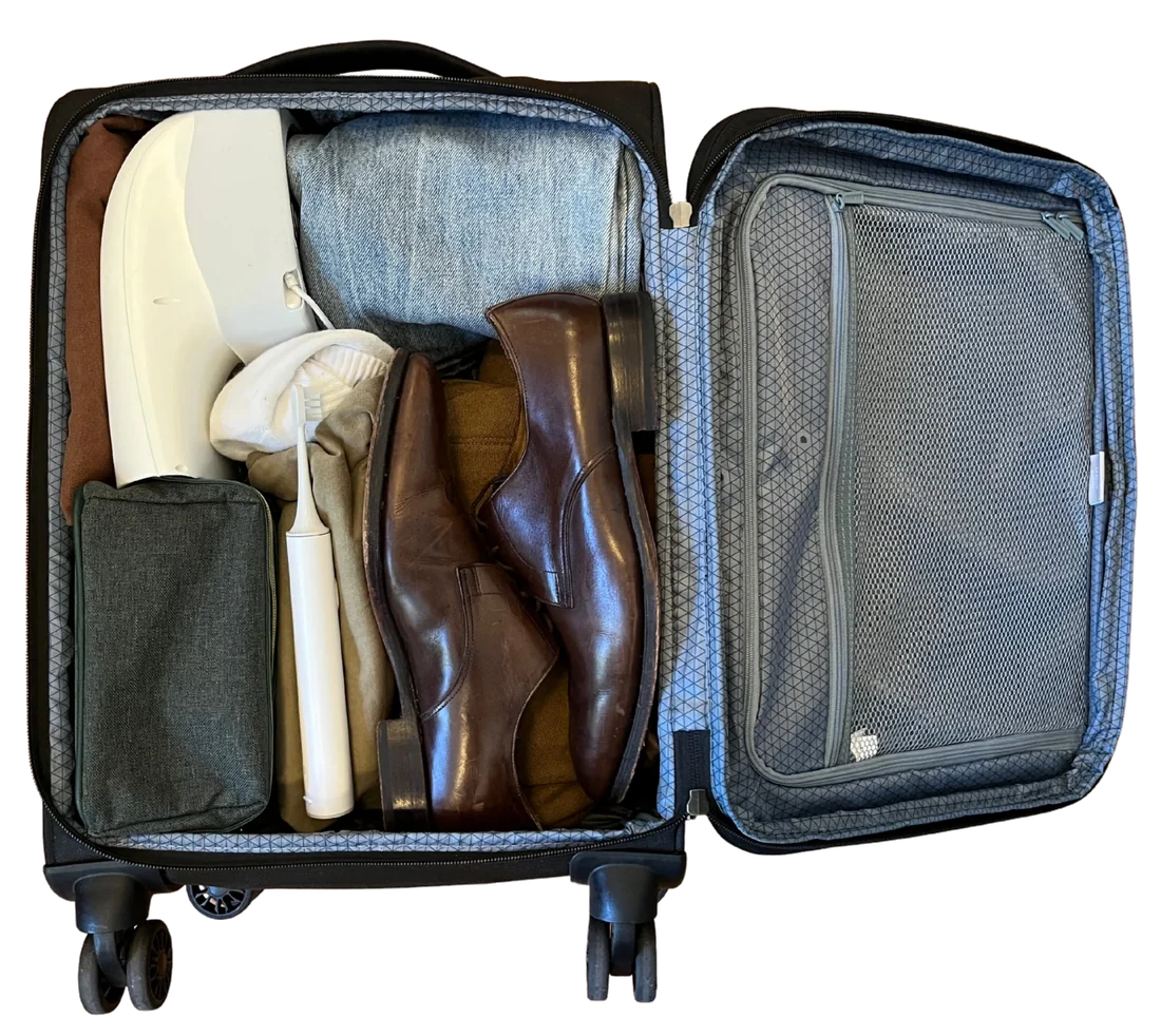 A Fantail unit packed inside an open carry-on suitcase.